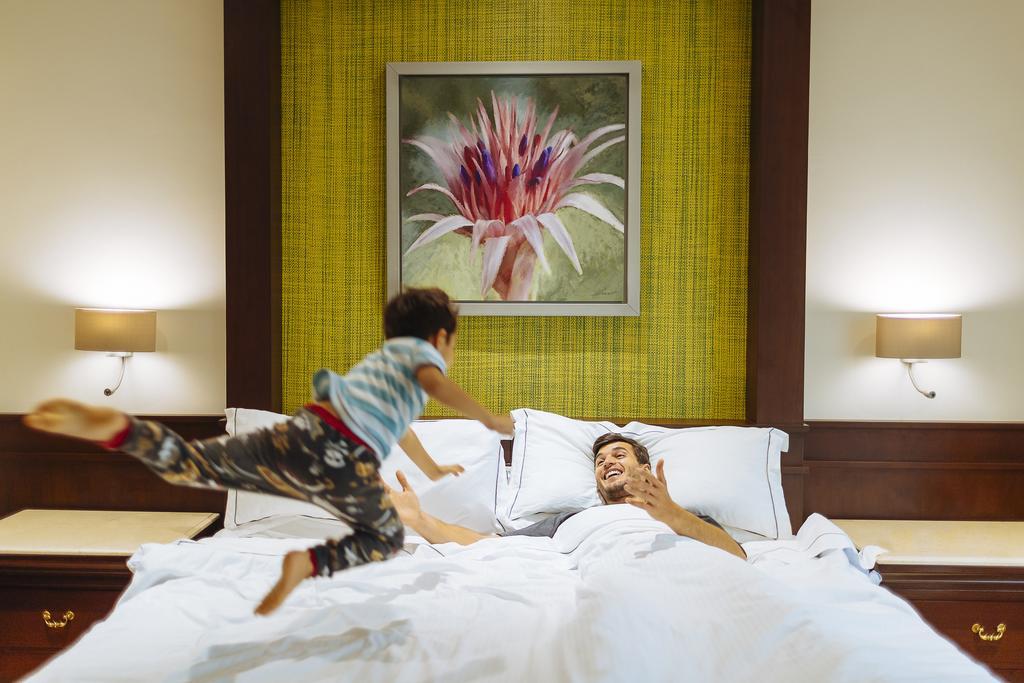 Hotel Occidental At Xcaret Destination Playa del Carmen Exteriér fotografie A child jumps on a bed.